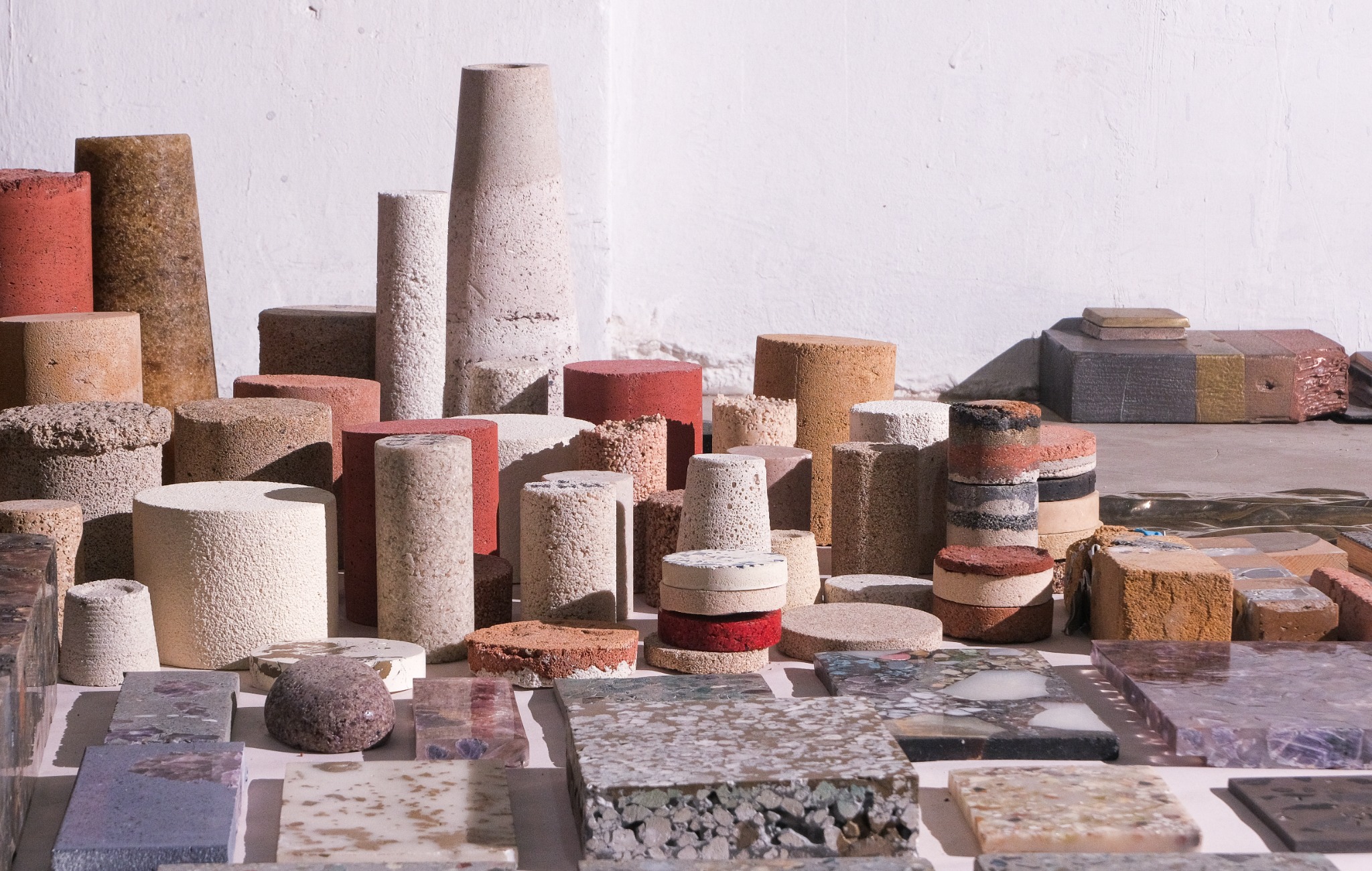 An array of cast material samples in varied colors, forms, and textures