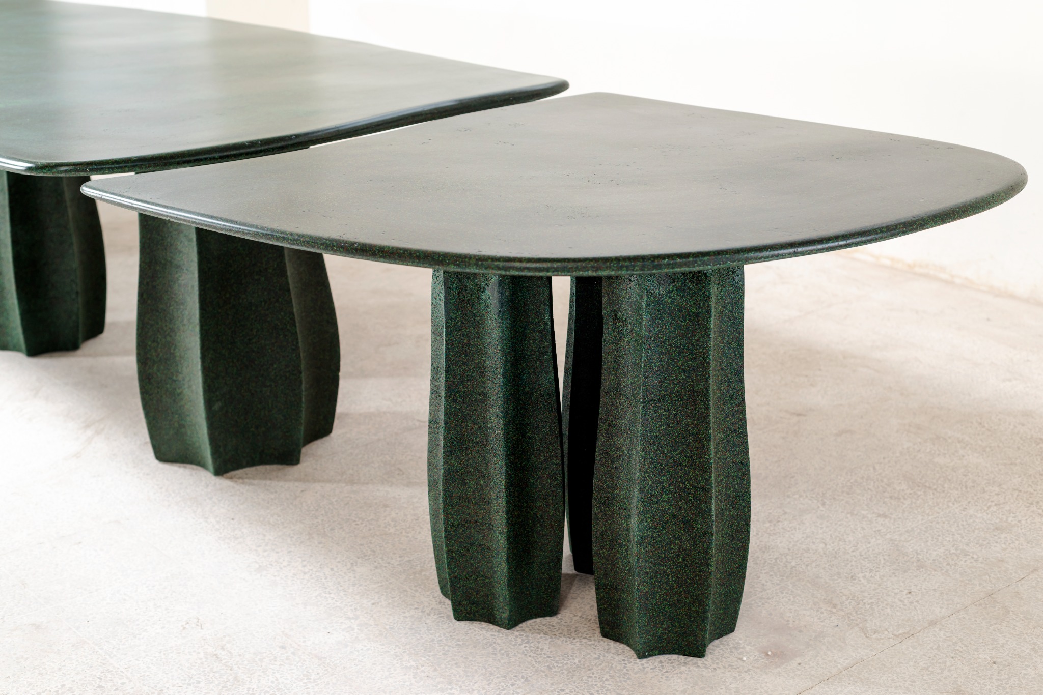 Pair of dark sculptural tables designed by Studio Manda