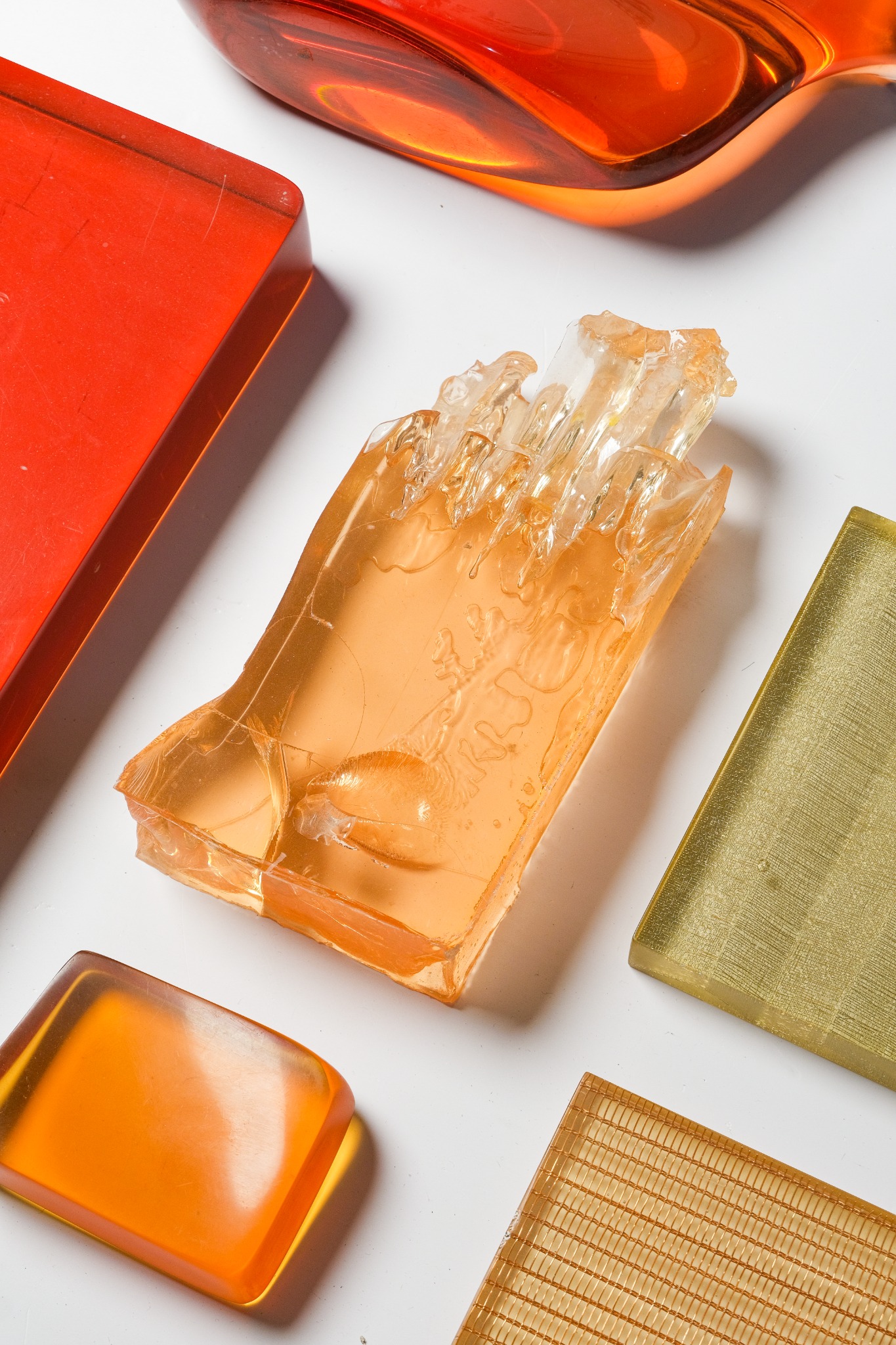 RezCast translucent resin samples in warm amber and red tones